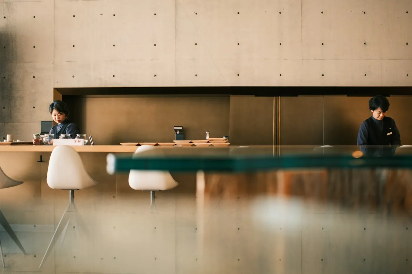 A quiet café counter with two staff members