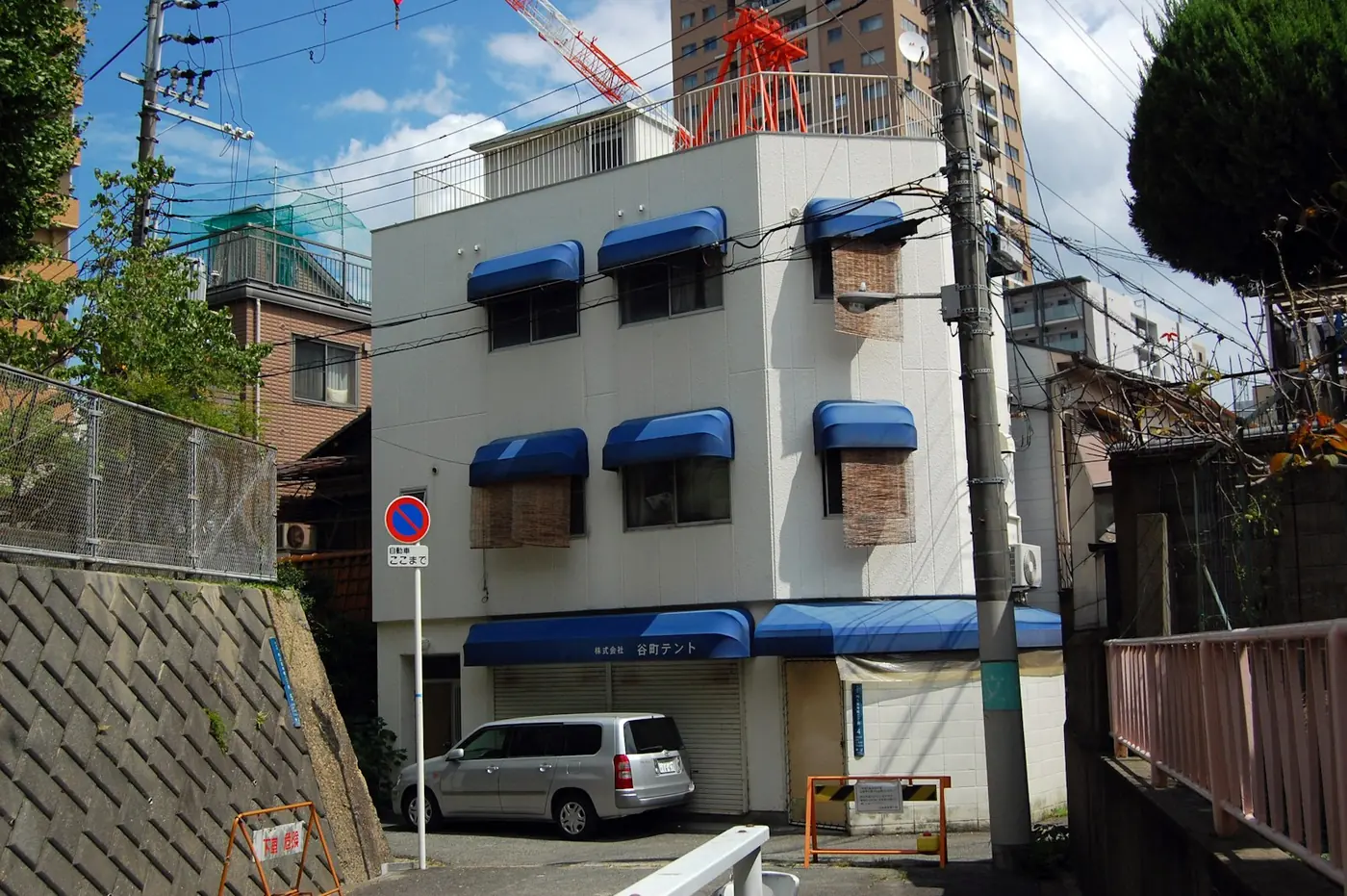 A small white apartment building in Japan