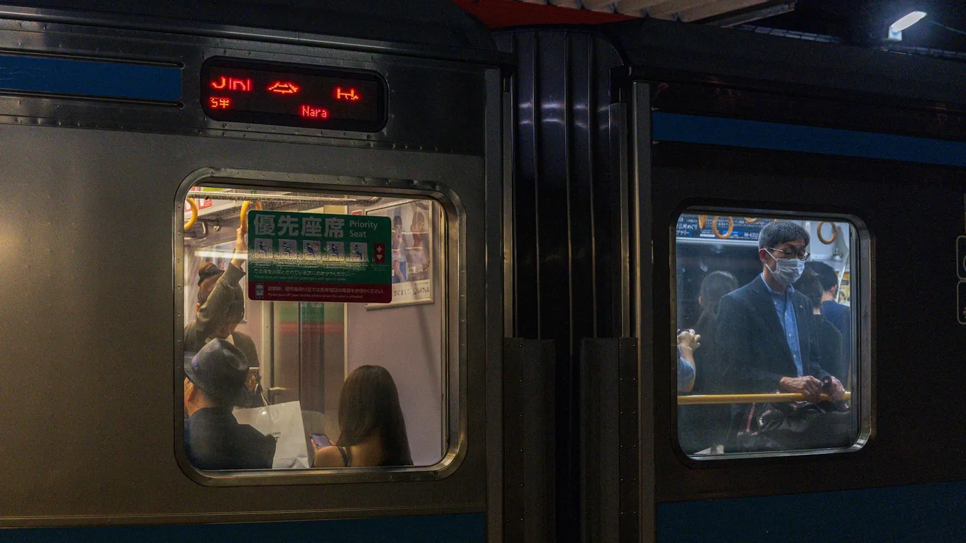 Passengers seen through the windows of a train at night