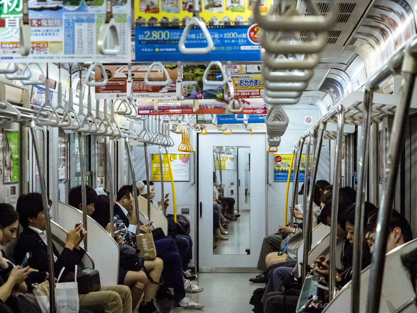 A busy Tokyo train car full of commuters